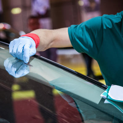 man polishing windshield